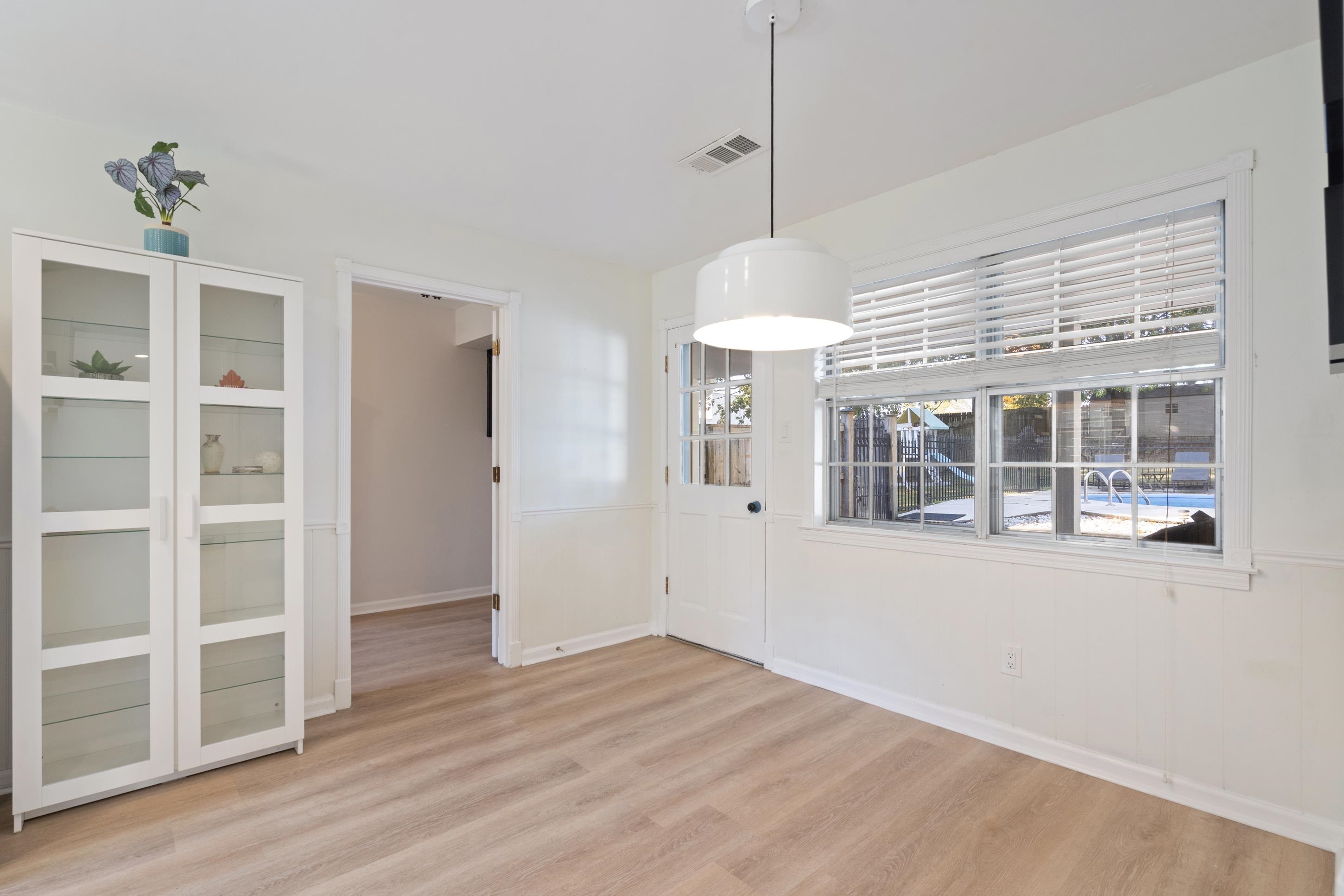 301 Dove Valley Road Collierville, TN 38017 - Photo 8 of 32 a view of an empty room with a window and wooden floor