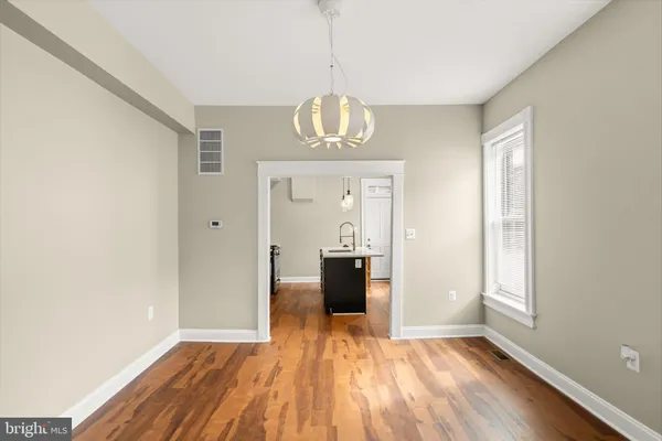 a view of a room with wooden floor windows and cabinet