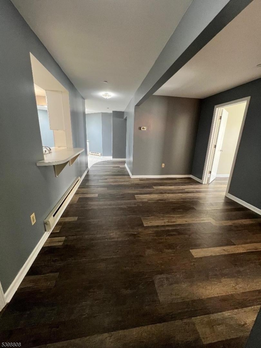 a view of room with window and wooden floor