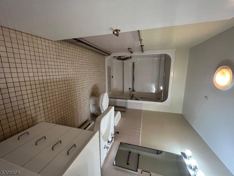 22 South Street, Unit 5 New Providence, NJ 07974 - Photo 7 of 12 a bathroom with a sink and a mirror