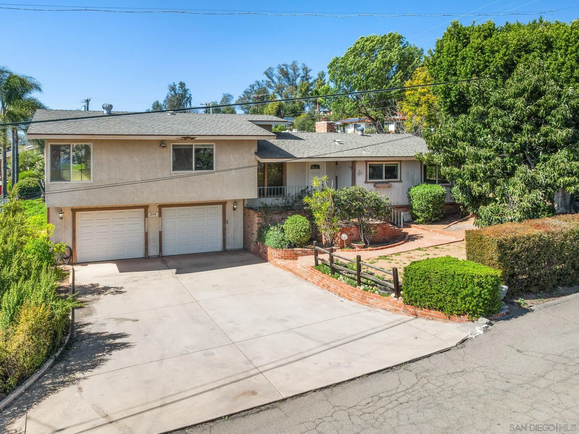 1999 Valley Rim Road El Cajon, CA 92019 - Photo 1 of 41 a front view of a house with a garden