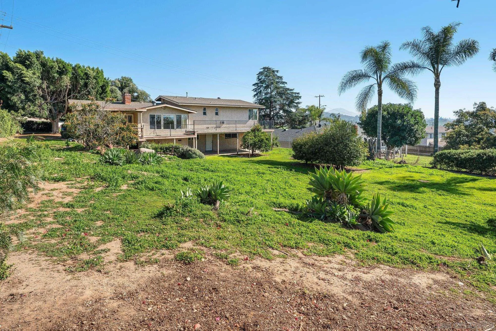 1999 Valley Rim Road El Cajon, CA 92019 - Photo 33 of 41 a front view of a house with a yard and potted plants