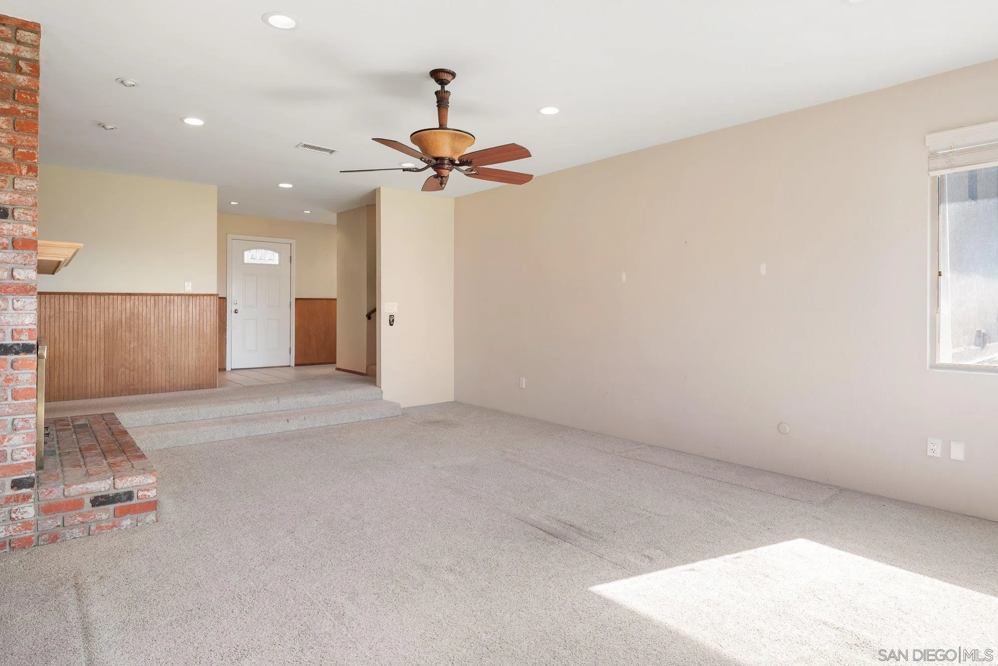 1999 Valley Rim Road El Cajon, CA 92019 - Photo 9 of 41 an empty room with a ceiling fan and window