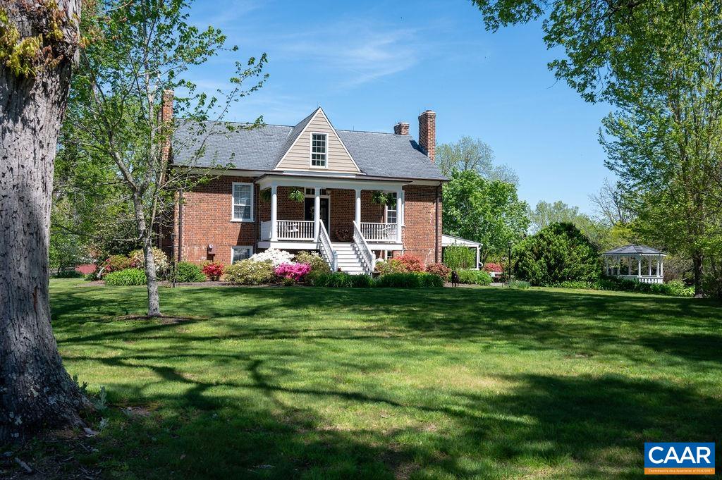 631 Old Rectory Lane Fork Union, VA 23055 - Photo 7 of 65 a front view of a house with a yard table and chairs