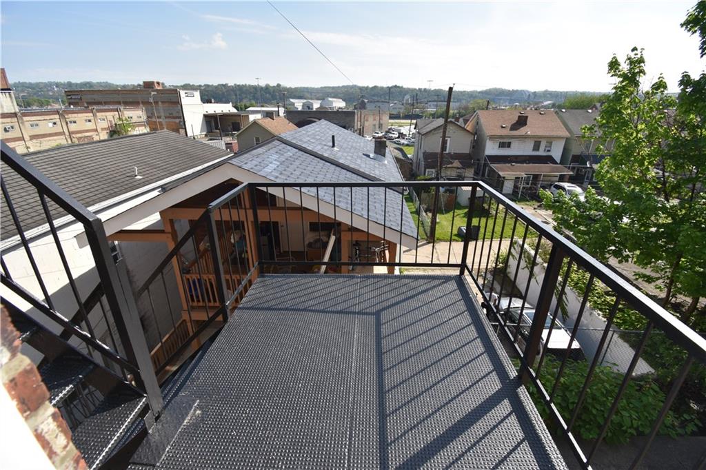 924 Island Avenue McKees Rocks, PA 15136 - Photo 14 of 29 a view of a balcony with wooden stairs and tennis court