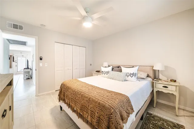 a bedroom with a bed and dresser with mirror