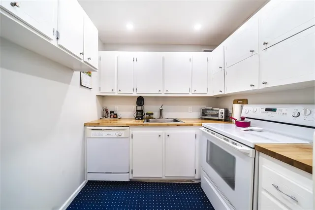 a kitchen with cabinets appliances and a sink