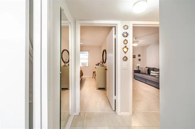 a bathroom with a granite countertop sink a toilet a mirror a vanity and shower