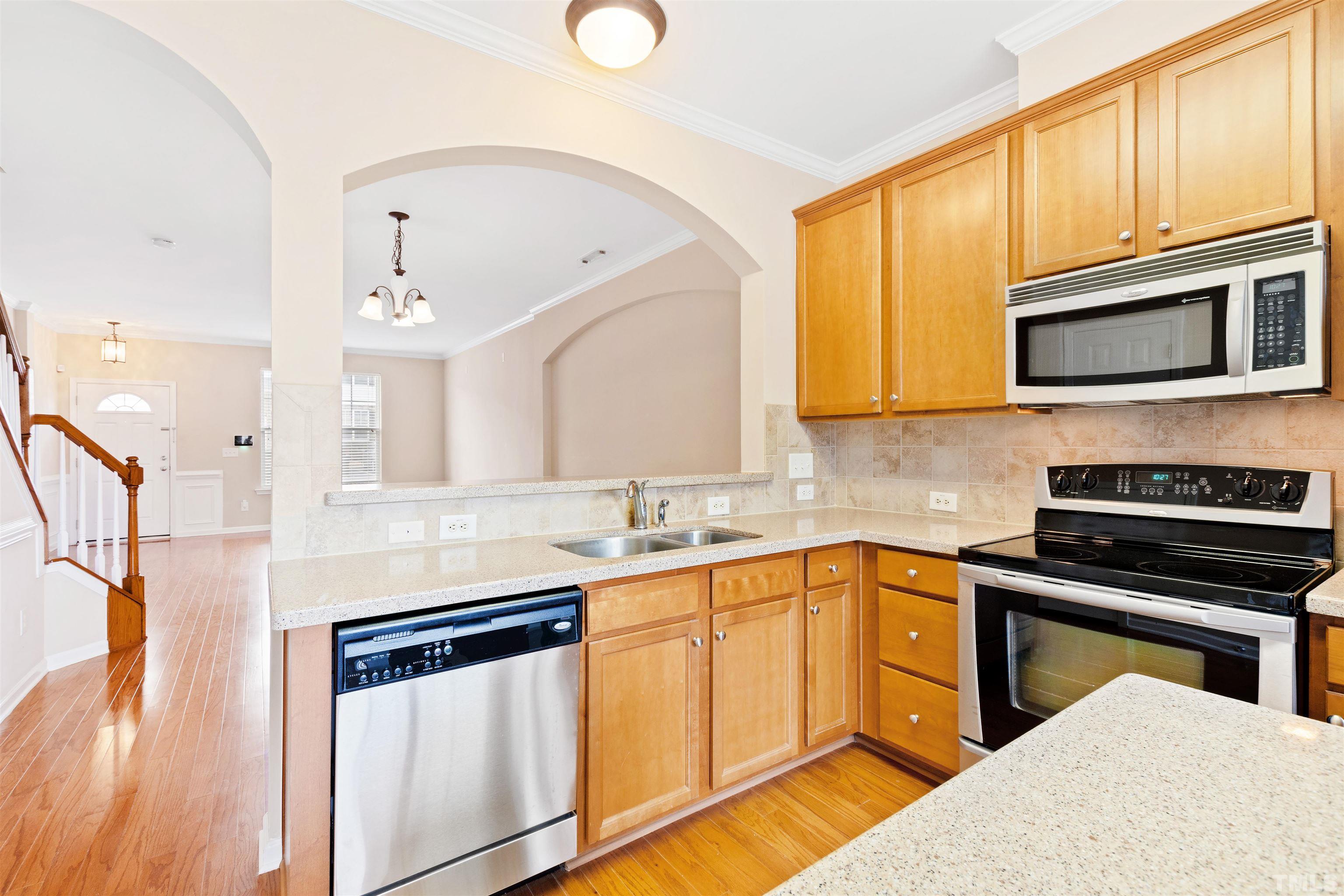 2962 Casona Way Raleigh, NC 27616 - Photo 15 of 40 a kitchen with stainless steel appliances granite countertop a sink and cabinets