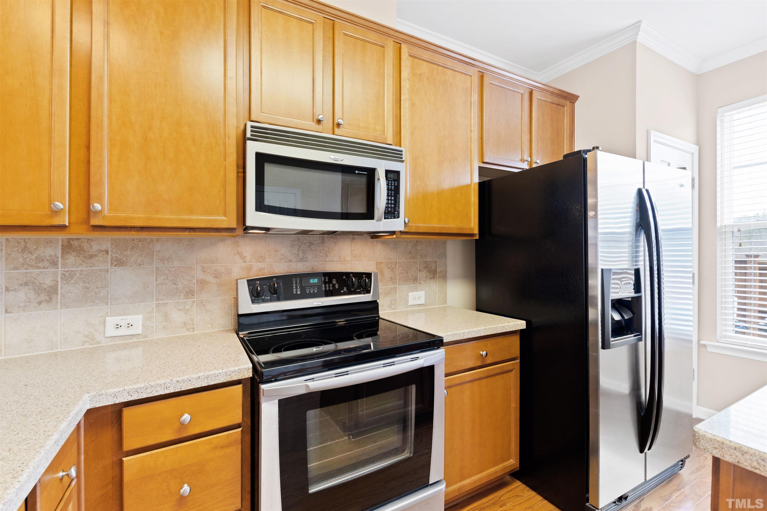 2962 Casona Way Raleigh, NC 27616 - Photo 16 of 40 a kitchen with stainless steel appliances granite countertop a refrigerator stove and microwave
