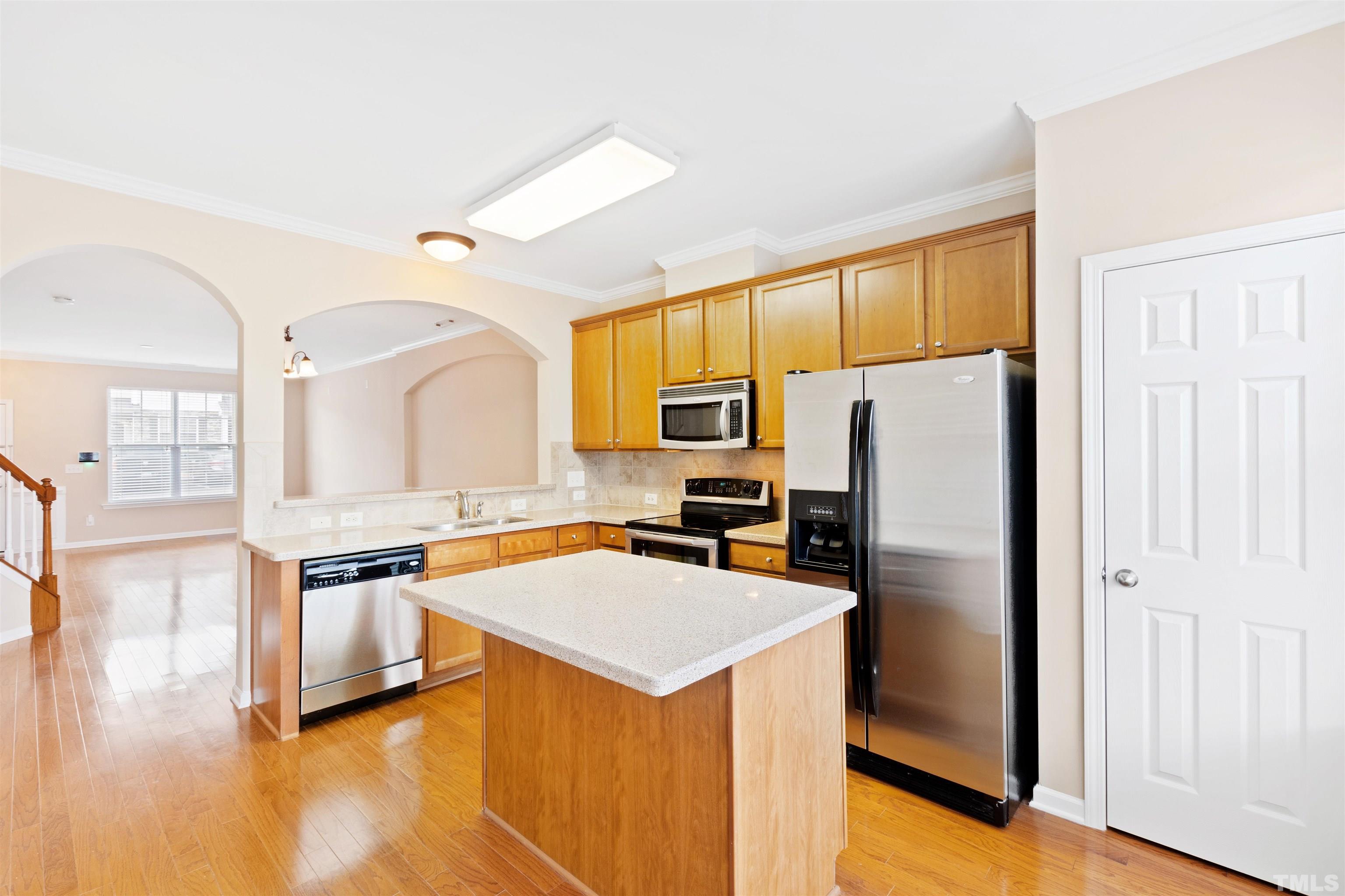 2962 Casona Way Raleigh, NC 27616 - Photo 17 of 40 a kitchen with stainless steel appliances a refrigerator sink and stove