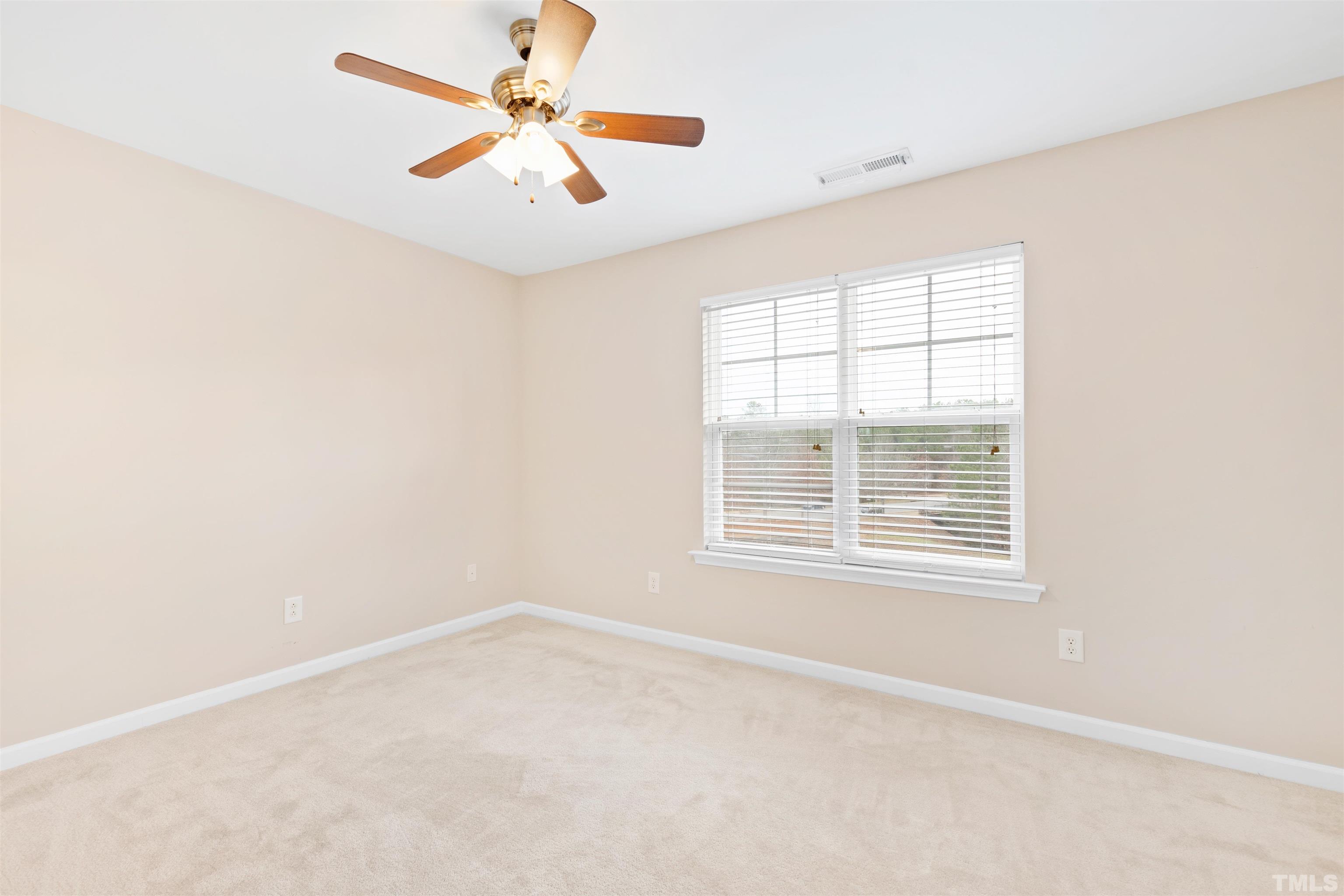 2962 Casona Way Raleigh, NC 27616 - Photo 21 of 40 an empty room with a window and a fan