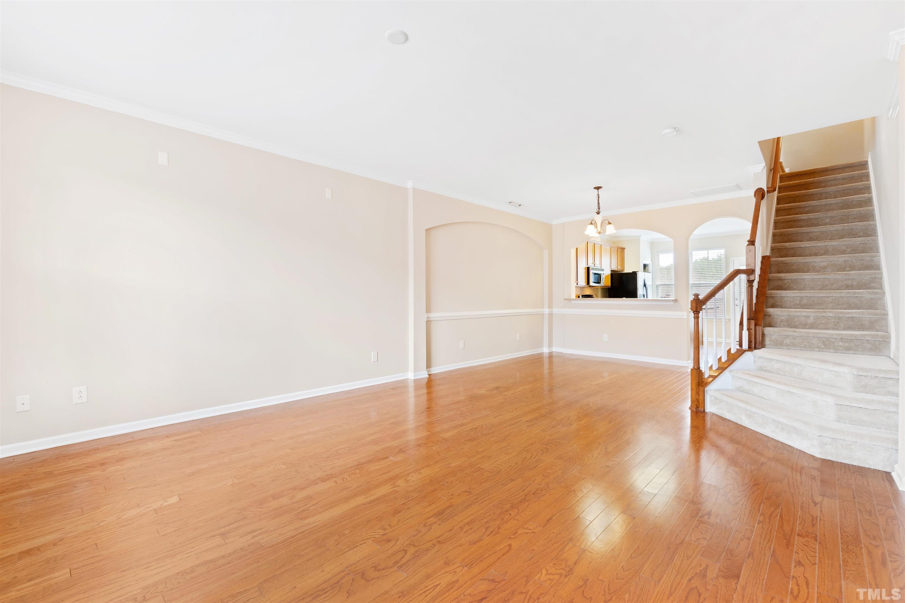 2962 Casona Way Raleigh, NC 27616 - Photo 3 of 40 a view of a kitchen with wooden floor and staircase