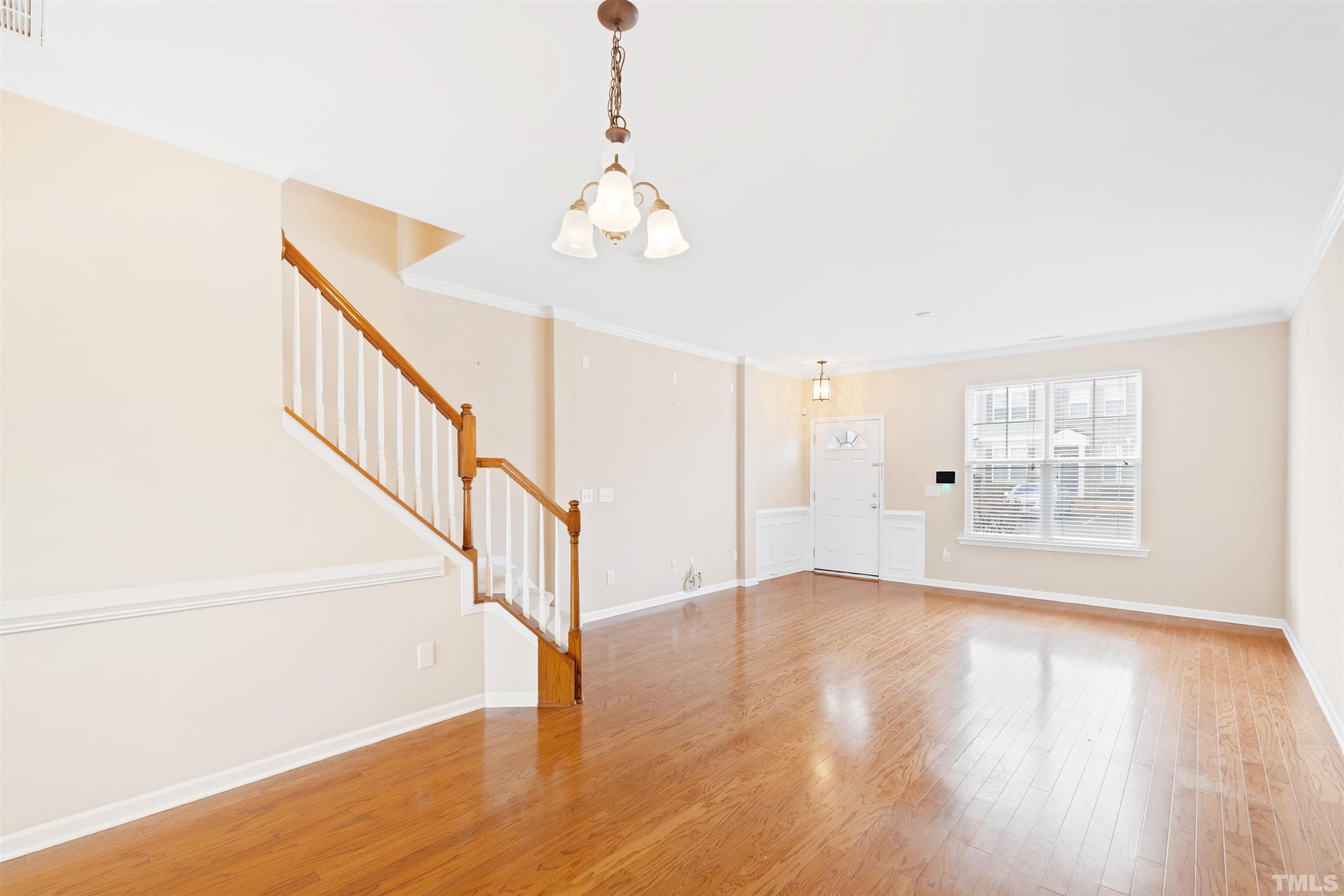 2962 Casona Way Raleigh, NC 27616 - Photo 8 of 40 a view of an empty room with wooden floor and a window