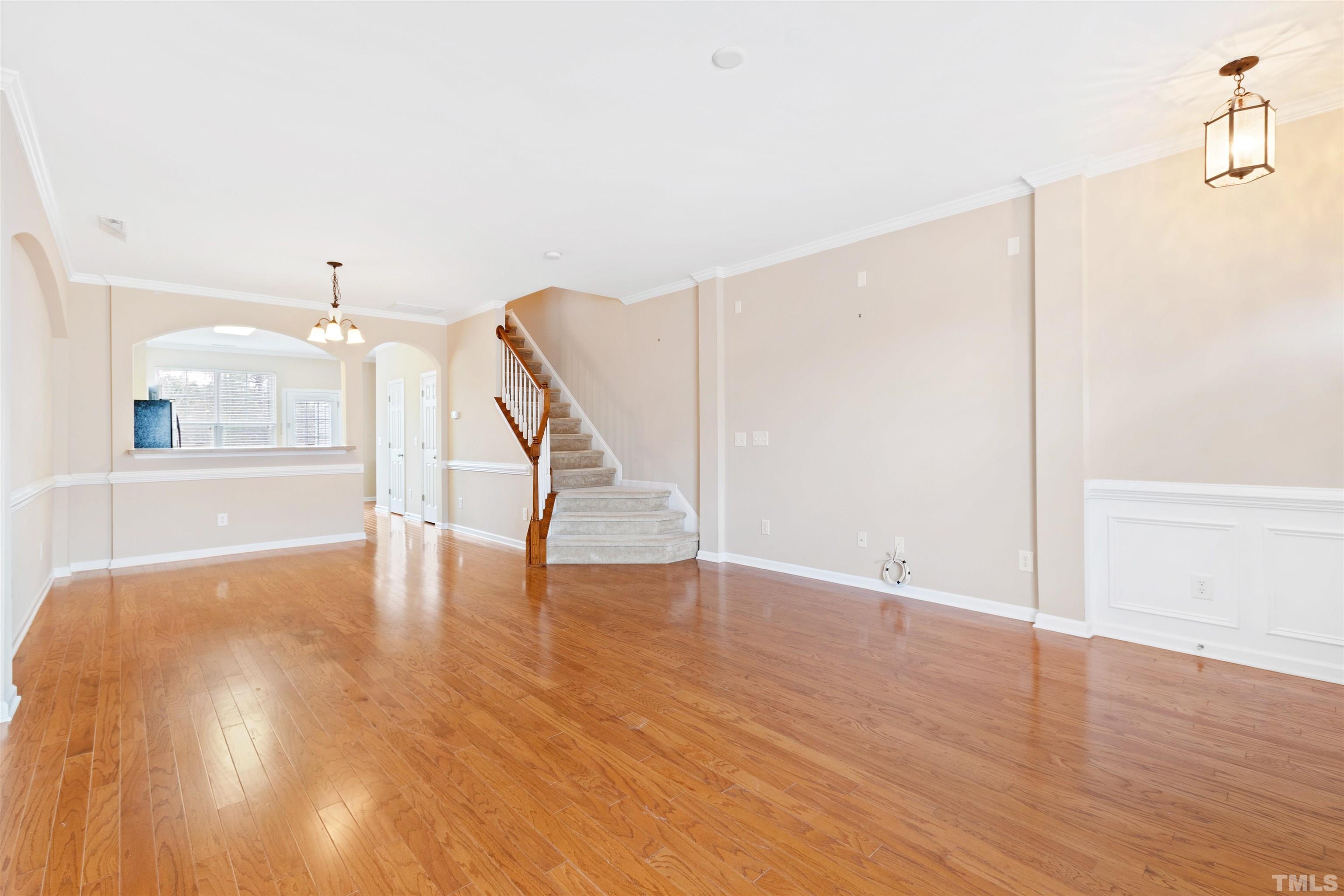 2962 Casona Way Raleigh, NC 27616 - Photo 10 of 40 a view of an empty room with wooden floor and a window