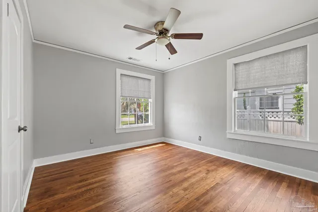 a view of a big room with wooden floor and a ceiling fan