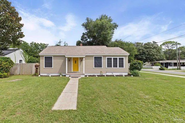 a front view of a house with a garden