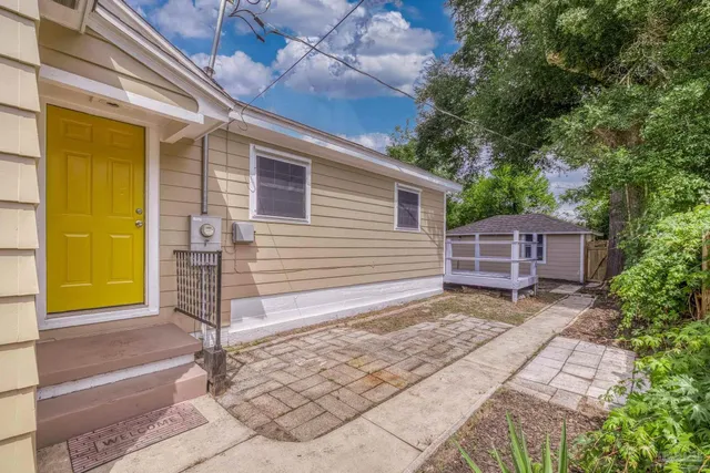 a view of house with backyard and outdoor seating