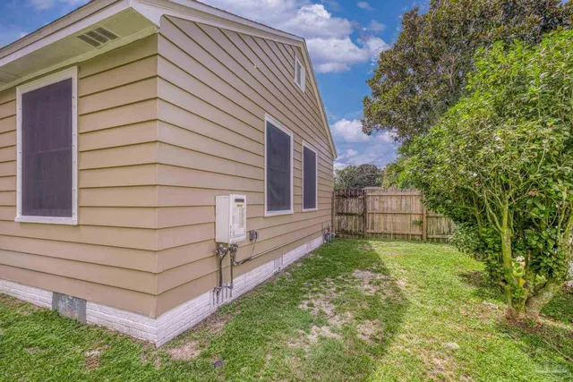 a view of a house with a backyard