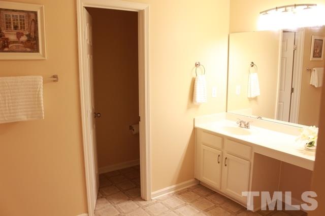 1621 Extine Lane Raleigh, NC 27610 - Photo 12 of 25 a bathroom with a sink and a mirror