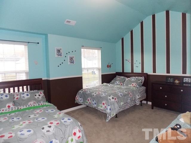1621 Extine Lane Raleigh, NC 27610 - Photo 15 of 25 a bedroom with a bed and a dresser