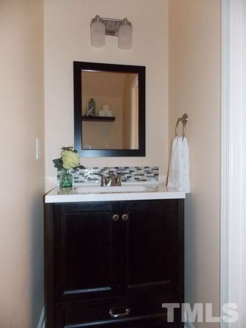 1621 Extine Lane Raleigh, NC 27610 - Photo 20 of 25 a bathroom with a sink and a mirror