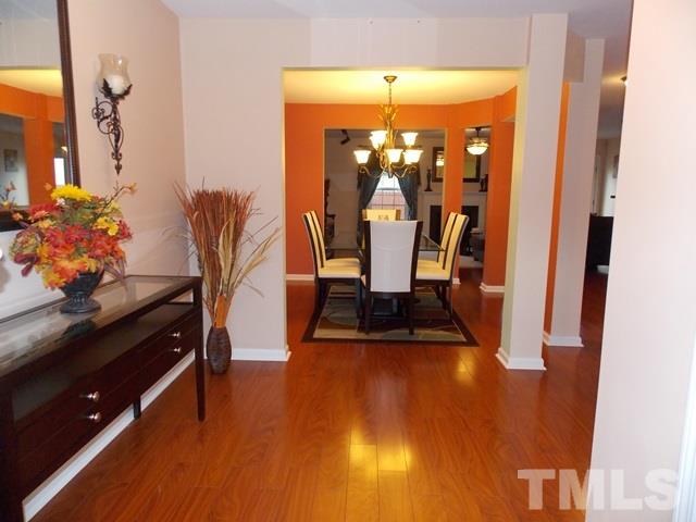 1621 Extine Lane Raleigh, NC 27610 - Photo 3 of 25 a view of a dining room with furniture and wooden floor