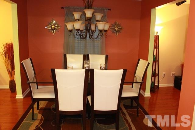 1621 Extine Lane Raleigh, NC 27610 - Photo 23 of 25 a view of a dining room with furniture and wooden floor