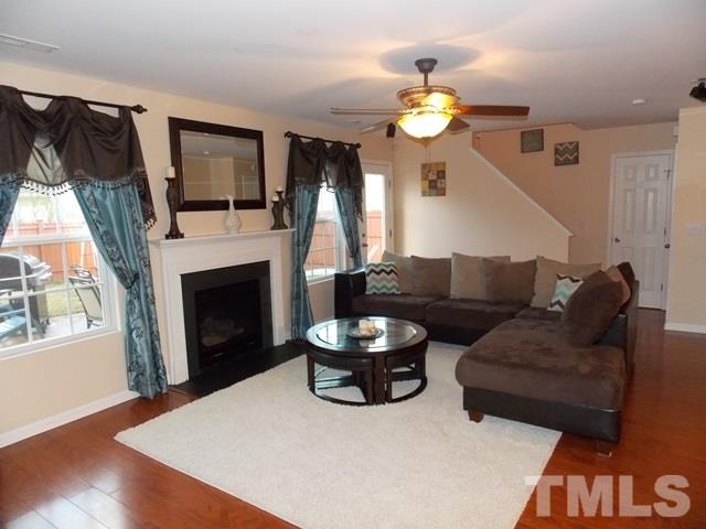 1621 Extine Lane Raleigh, NC 27610 - Photo 4 of 25 a living room with furniture a fireplace and a flat screen tv