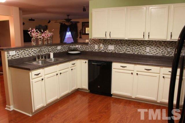1621 Extine Lane Raleigh, NC 27610 - Photo 6 of 25 a kitchen with stainless steel appliances granite countertop a sink and cabinets