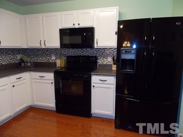 1621 Extine Lane Raleigh, NC 27610 - Photo 8 of 25 a kitchen with a sink and a refrigerator