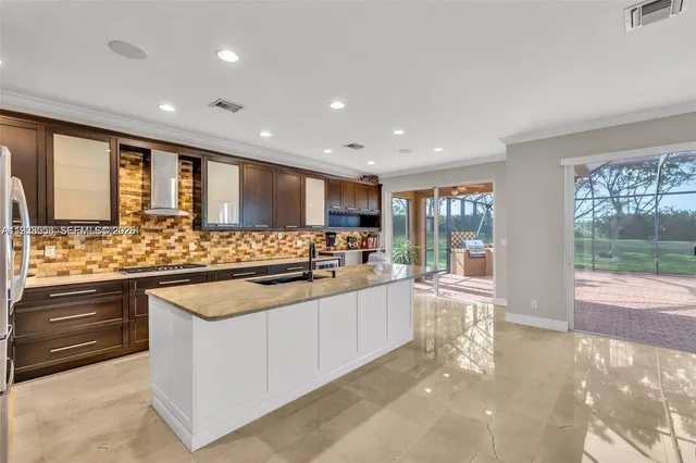 a large kitchen with stainless steel appliances kitchen island granite countertop a large counter top and wooden floors
