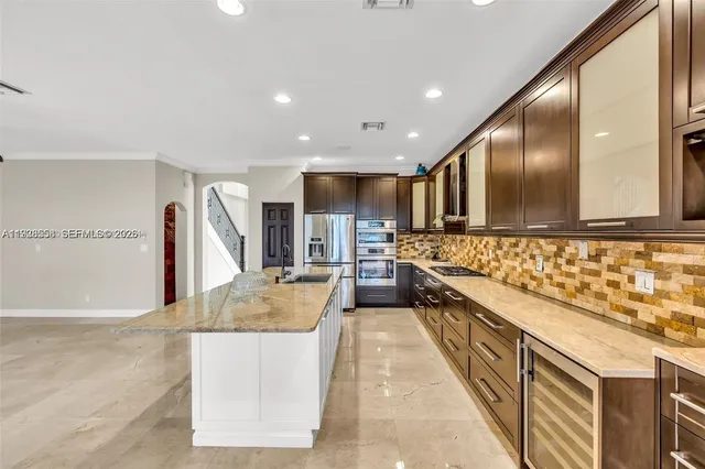 a kitchen with granite countertop a stove and a sink with living room