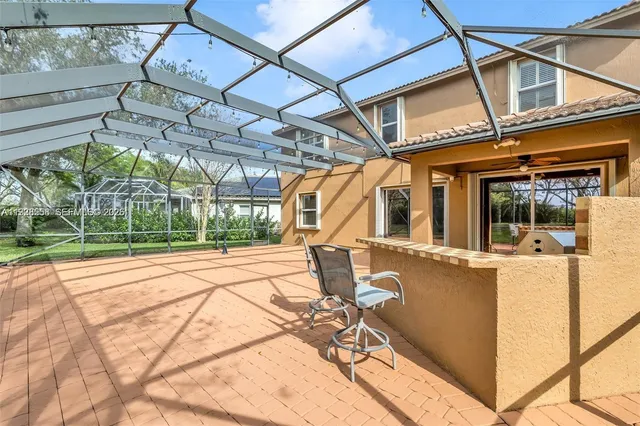 a view of a house with backyard and sitting area