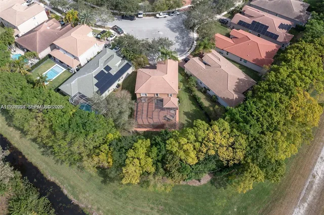 an aerial view of a house with a yard