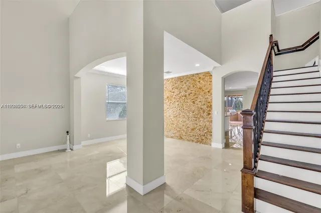 a view of entryway with wooden floor and stairs