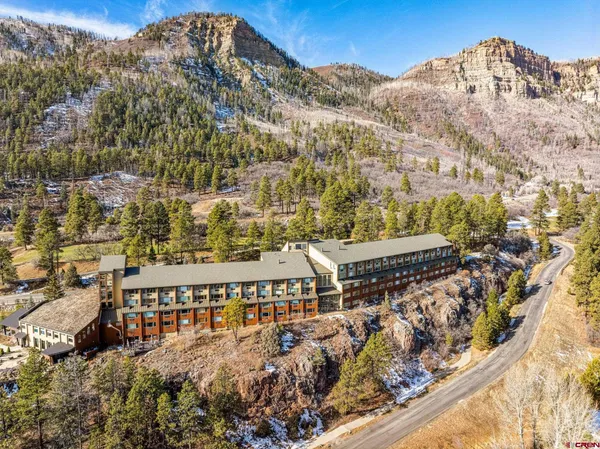 a view of a large building with a mountain in the background