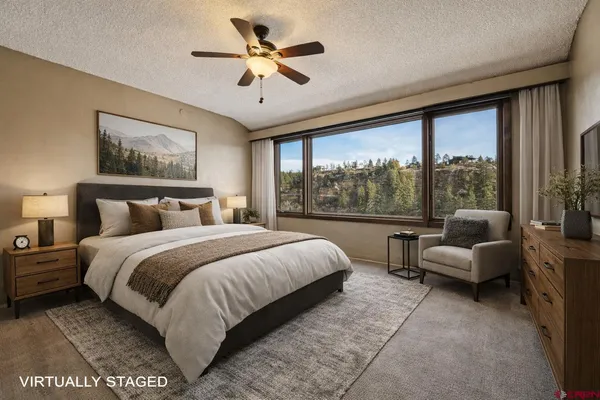 a bedroom with a bed and a large window