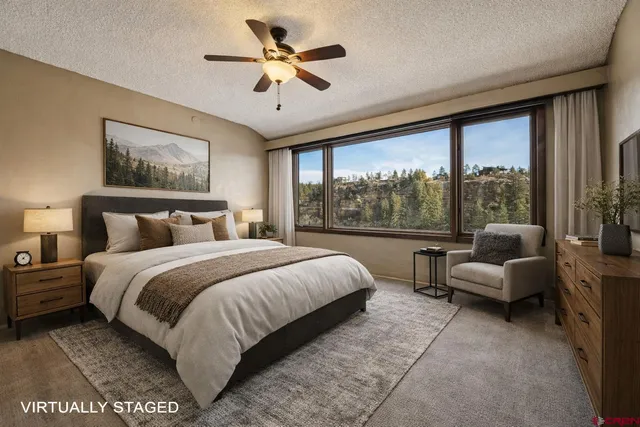 a bedroom with a bed and a large window