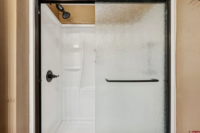 a bathroom with a granite countertop toilet sink and mirror
