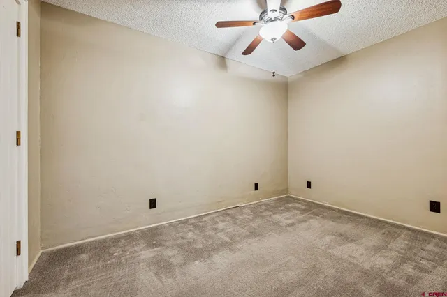 a bathroom with a granite countertop sink toilet and a mirror