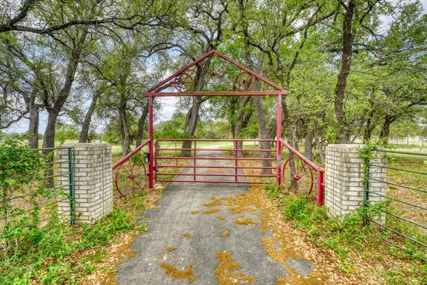 a view of pathway along with wooden fence