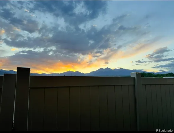 a view of balcony with furniture and a garden