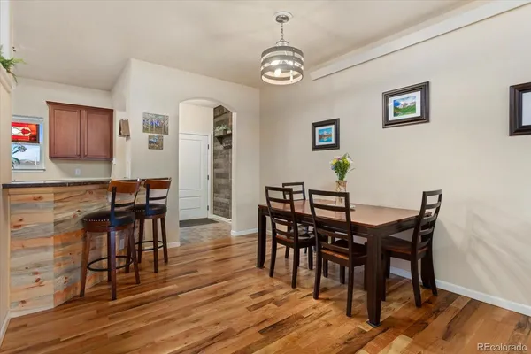 a view of a dining room with furniture and wooden floor