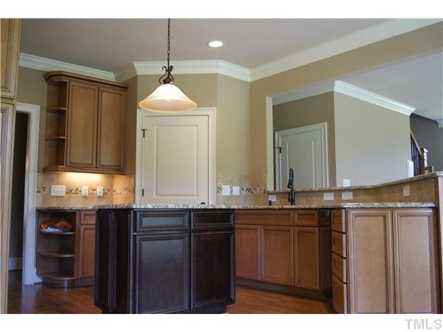 8306 Rue Cassini Court Raleigh, NC 27615 - Photo 8 of 19 Kitchen with island, tile back splash, pantry, lots of cabinets. Kitchen