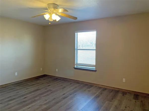 an empty room with wooden floor and closet