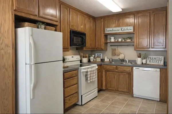 a kitchen with a refrigerator sink and microwave