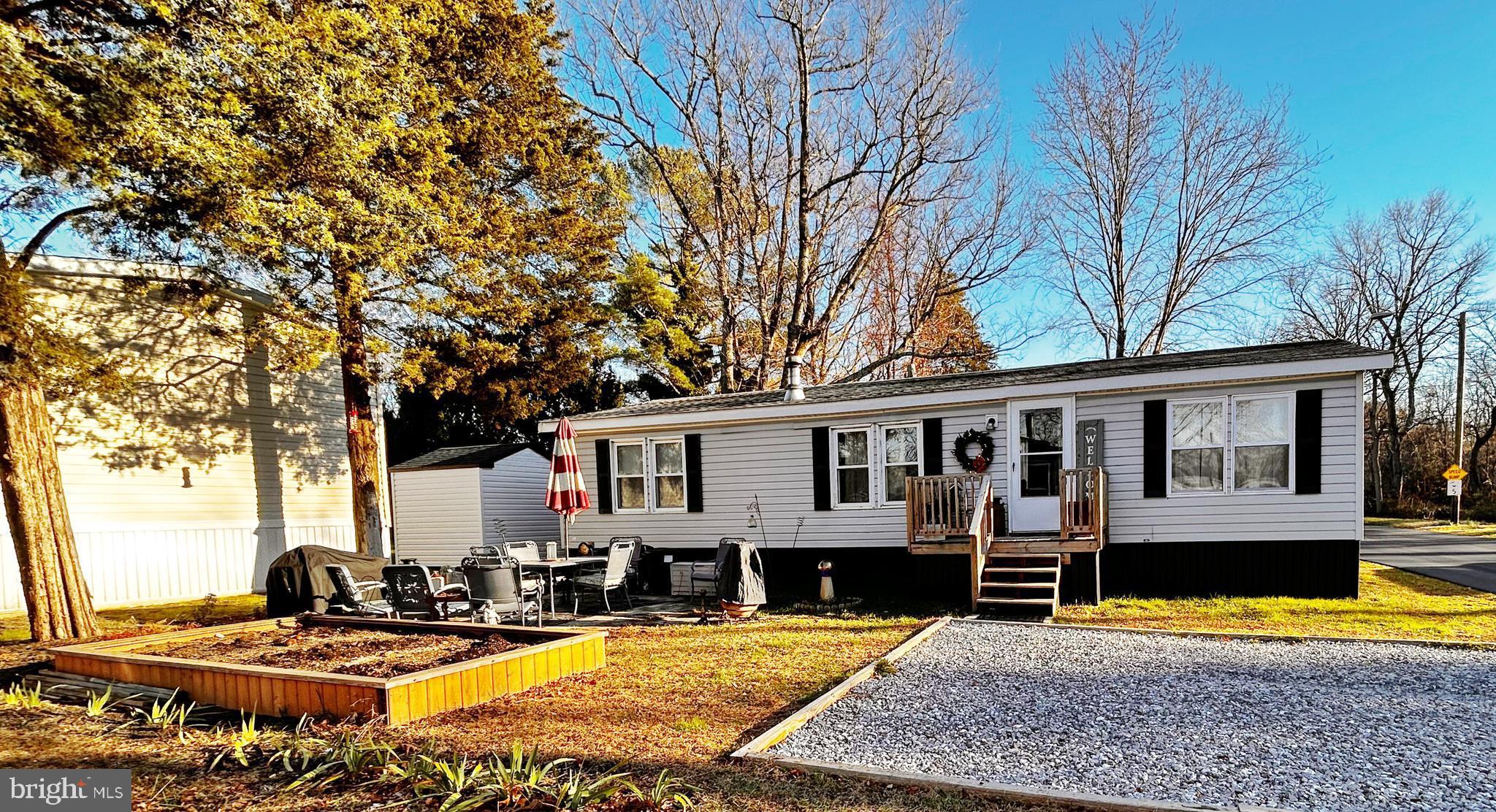 a view of a house with pool and chairs