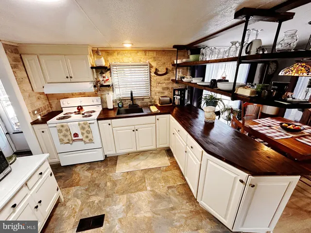 a kitchen with stainless steel appliances granite countertop a sink and cabinets