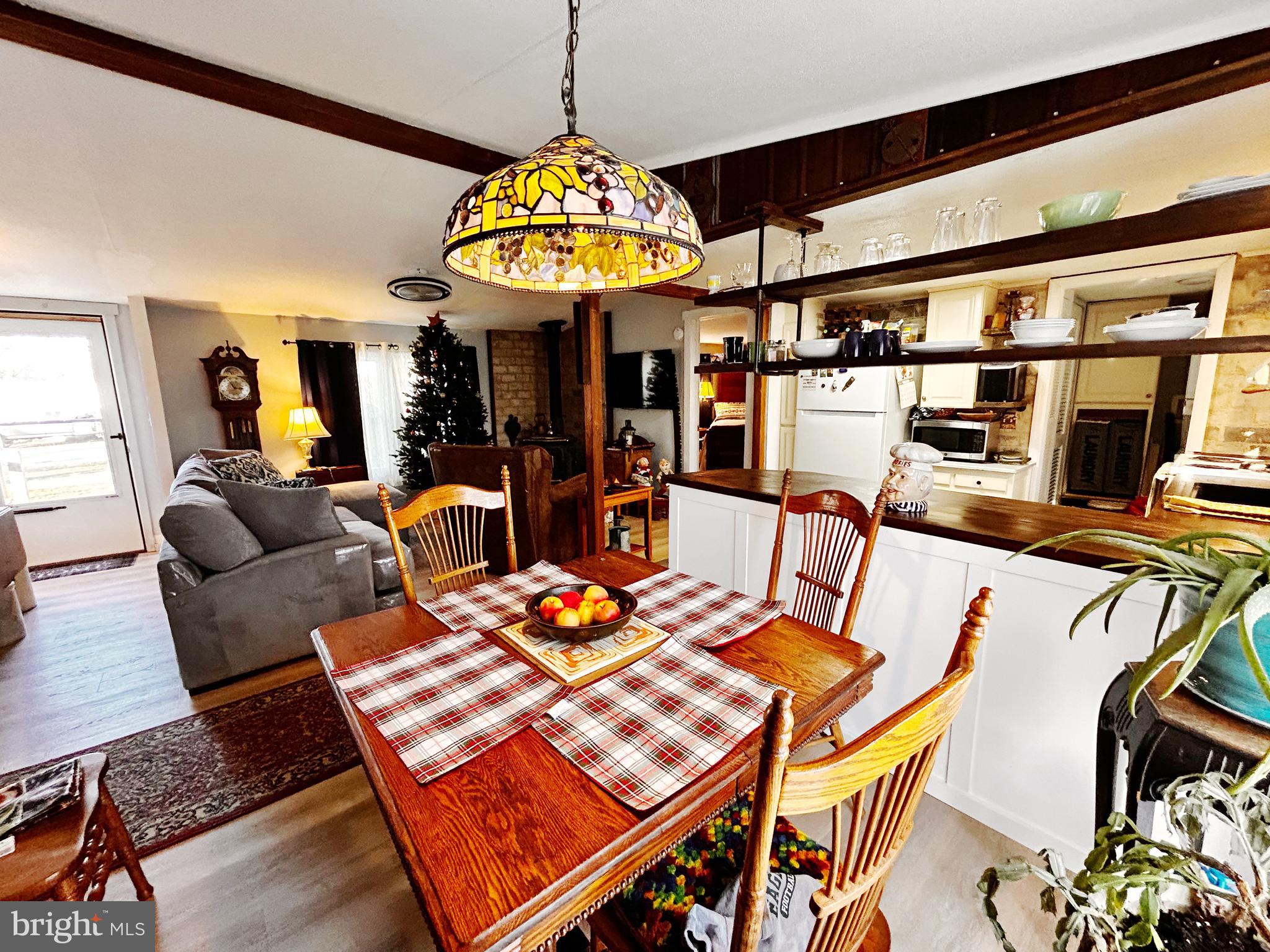 260 Marshall Mill Road, Unit 146 Malaga, NJ 08328 - Photo 13 of 22 a view of a dining room with furniture a chandelier and wooden floor